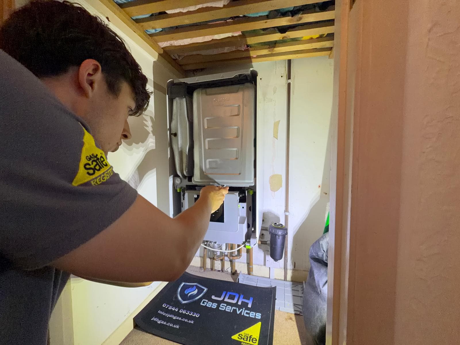 Jamie servicing a Bosch boiler tucked under the rafters