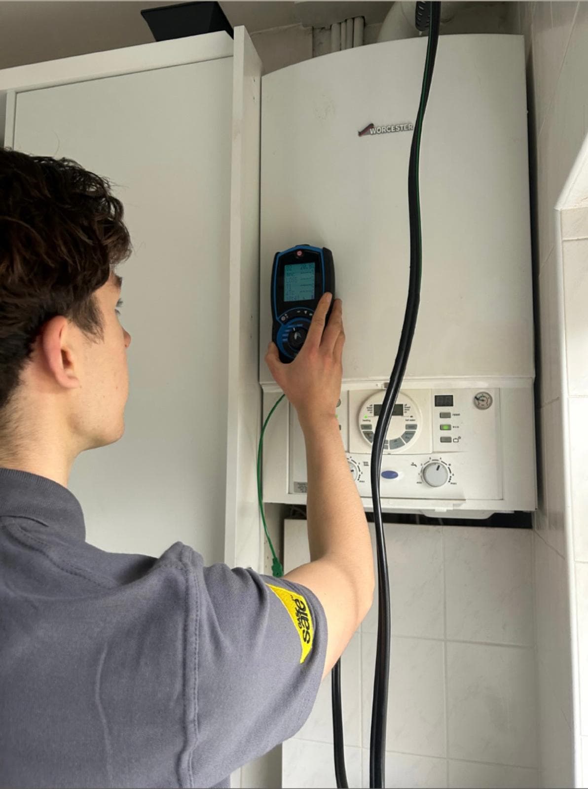 Diagnosing a boiler fault with a flue gas analyser during a repair in Burgess Hill
